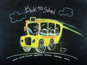 Tea with the Editor Colorful chalk drawing on a blackboard of a yellow school bus with smiling children and a driver, with "Back to School" written above.