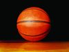 Tallahassee opens registration for fall sports Close-up of an orange basketball resting on a wooden floor against a black background.